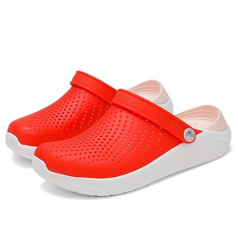 Pair of red perforated slip-on garden sandals with white sole and strap on Tampa Home & Garden Store