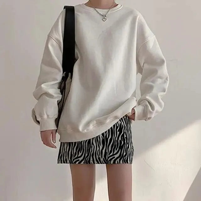 Two-piece oversized cream fleece sweatshirt with zebra-print mini skirt, black bag strap on Tampa Home & Garden Store