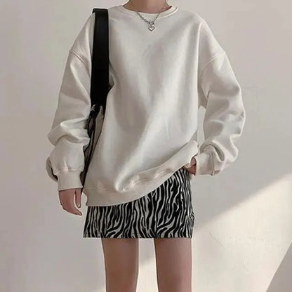 Two-piece oversized cream fleece sweatshirt with zebra-print mini skirt, black bag strap on Tampa Home & Garden Store