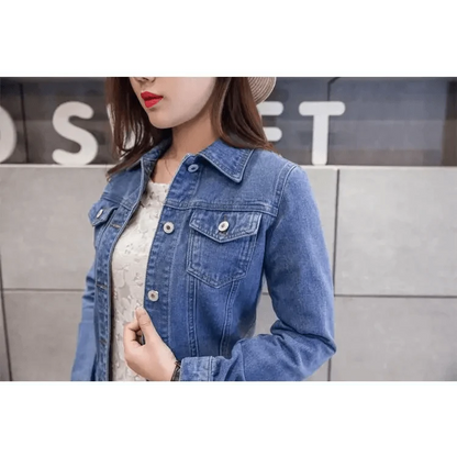 Women’s blue denim trucker jacket with front pockets and silver buttons, long sleeves on Tampa Home & Garden Store