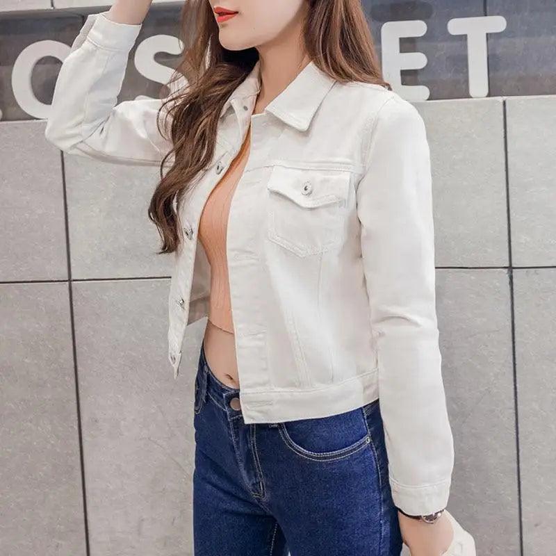 White denim trucker jacket with chest pockets and metal buttons worn open over peach top on Tampa Home & Garden Store