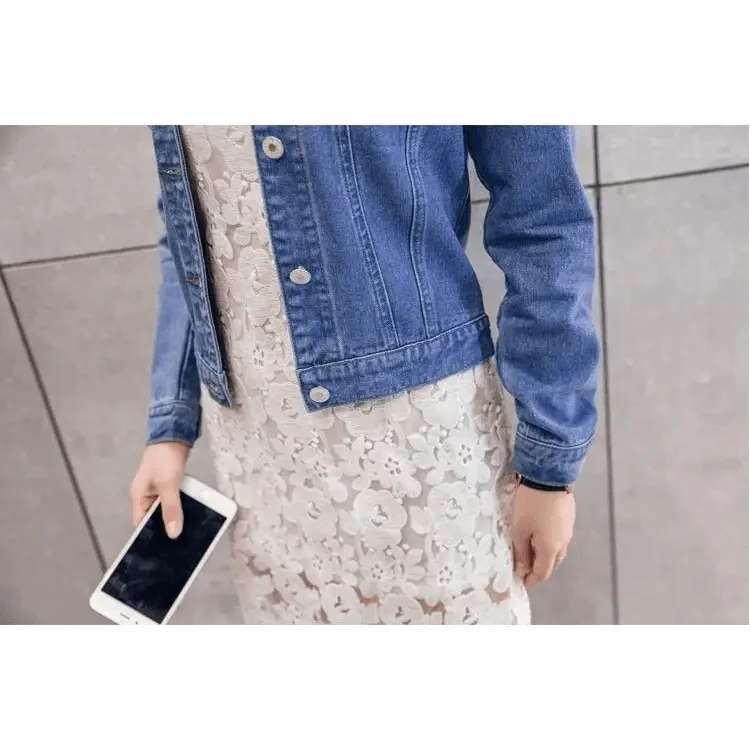 Stevvex blue trucker denim jacket worn over white lace dress, woman holding smartphone on Tampa Home & Garden Store