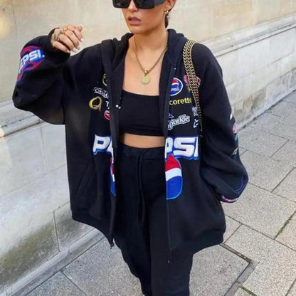 Stevvex black hooded windbreaker jacket with colorful Pepsi patch graphics worn by a woman on Tampa Home & Garden Store