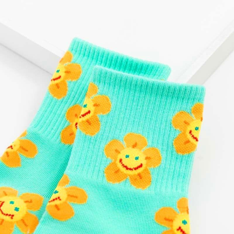 Stevvex crew socks pair with cartoon orange flowers on turquoise background on Tampa Home & Garden Store