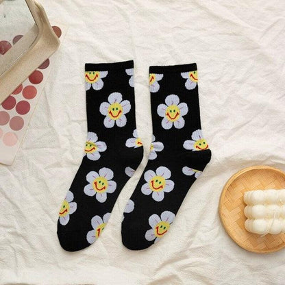 Stevvex women's crew socks black with white daisies and yellow smiley centers, pair on Tampa Home & Garden Store