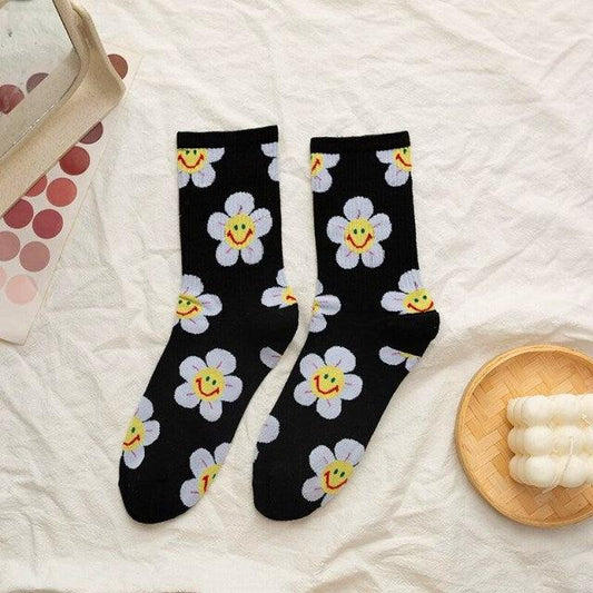 Stevvex women's crew socks black with white daisies and yellow smiley centers, pair on Tampa Home & Garden Store