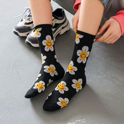 Women socks Stevvex black background white daisy prints with yellow smiley centers on Tampa Home & Garden Store