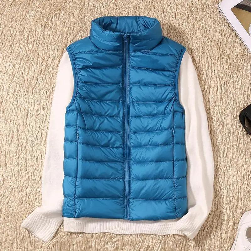 Stevvex blue quilted down vest with high collar, sleeveless puffer over white sweater on Tampa Home & Garden Store