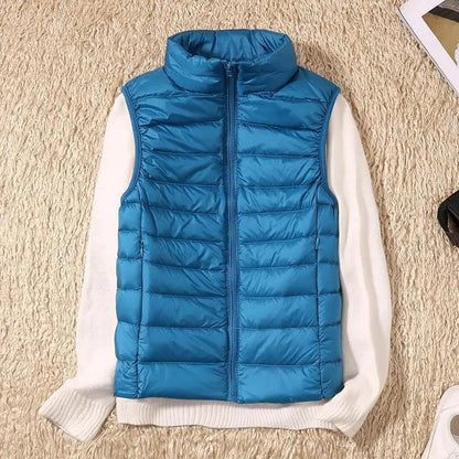 Stevvex blue quilted down vest with high collar, sleeveless puffer over white sweater on Tampa Home & Garden Store