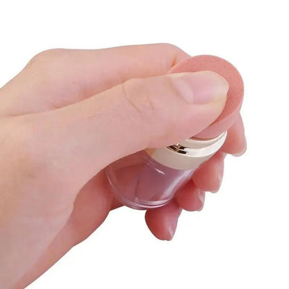 Clear glass makeup bottle with pink round sponge applicator and silver cap on Tampa Home & Garden Store