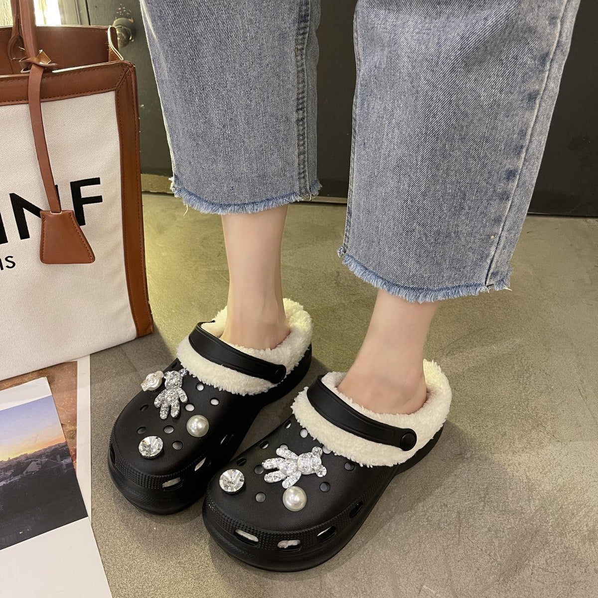 Stevvex black faux-fur lined slip-on clogs with crystal accents, worn with cropped denim on Tampa Home & Garden Store