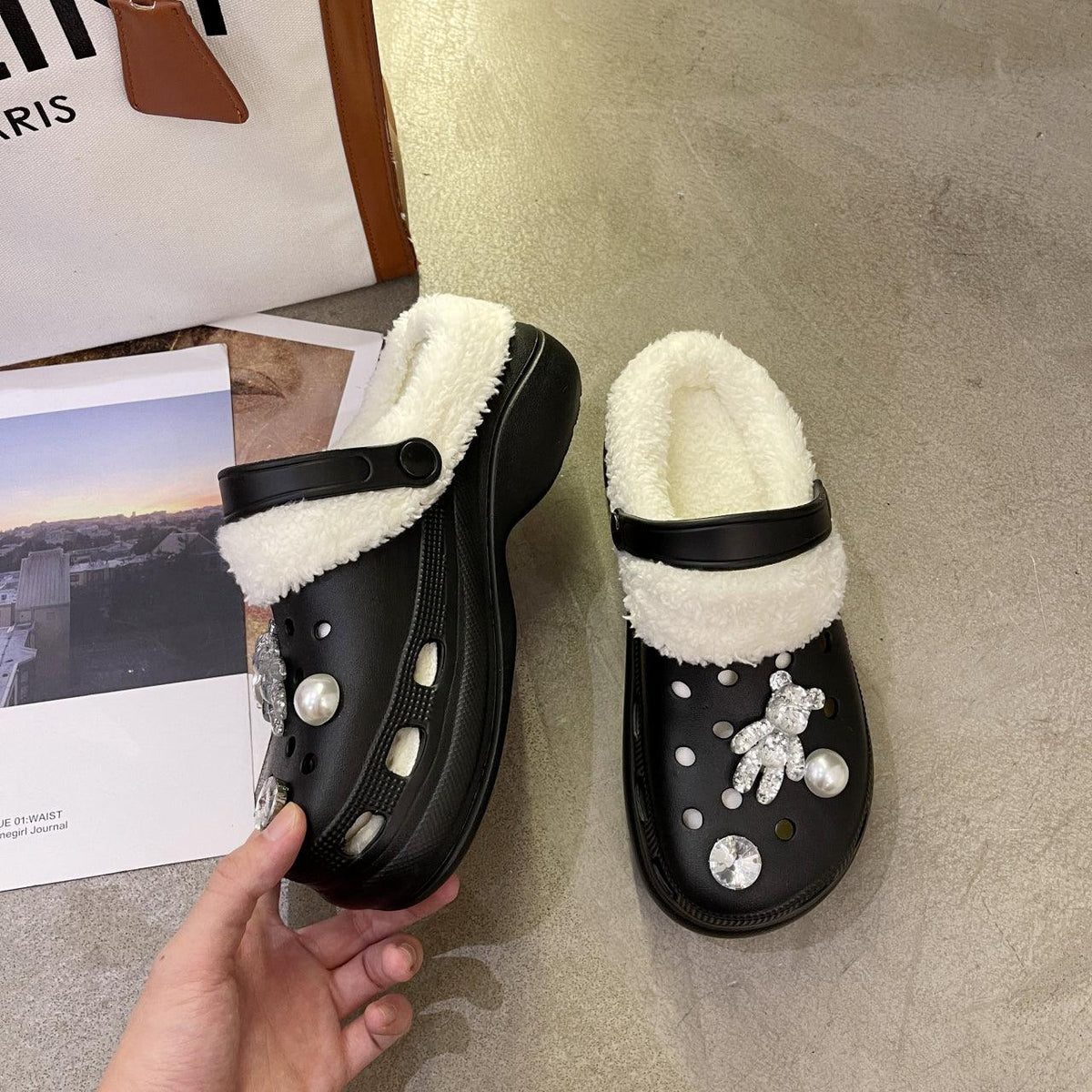 Stevvex black fuzzy-lined slippers pair with faux shearling trim and jeweled embellishments on Tampa Home & Garden Store