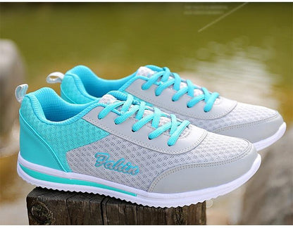 Teal mesh women's sneakers with grey overlays and turquoise laces, pair on display on Tampa Home & Garden Store