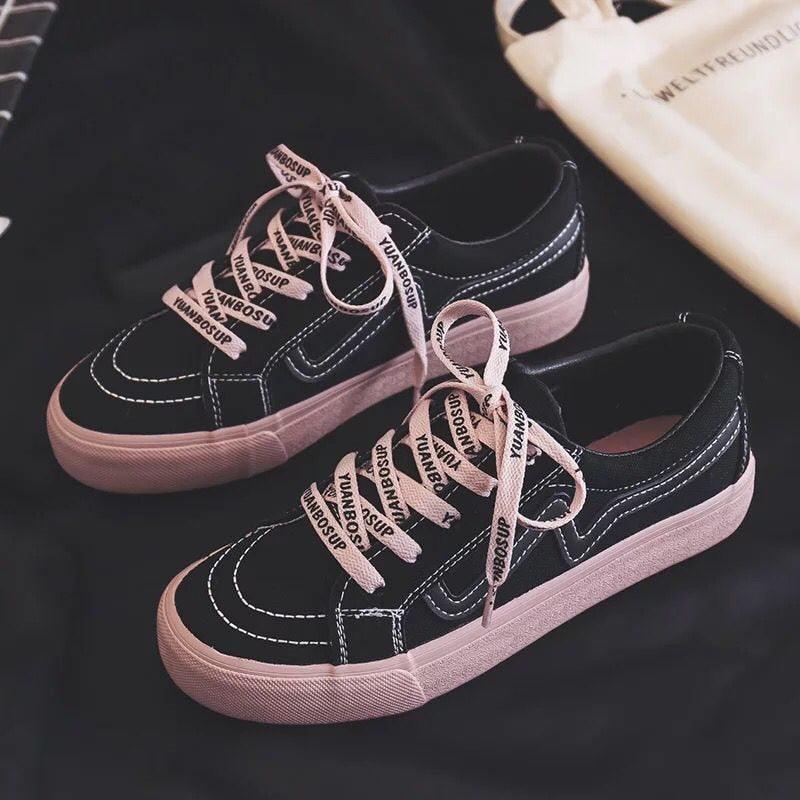 Stevvex women's black canvas sneakers, low-top lace-up pair with pink sole and white stitching on Tampa Home & Garden Store