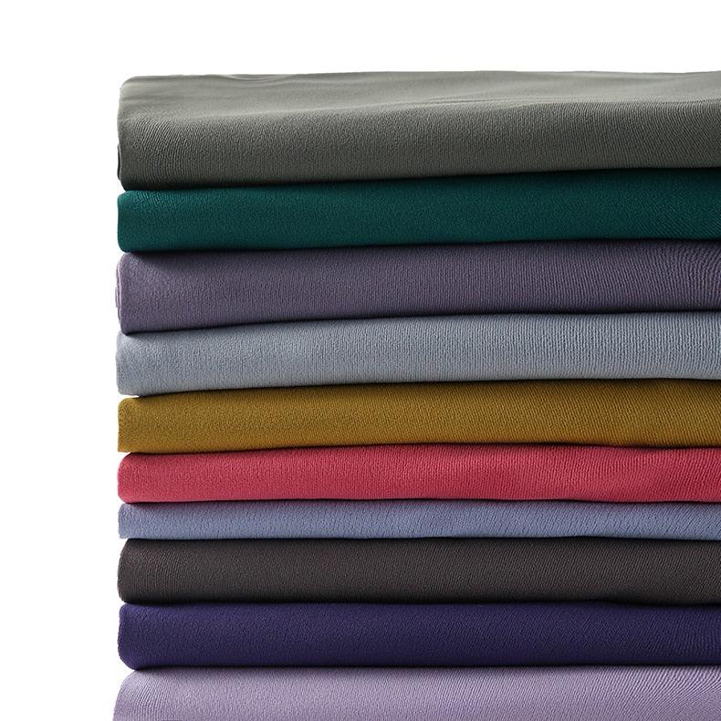 Stevvex women's yoga leggings fabric swatches in stacked colorful folds on Tampa Home & Garden Store