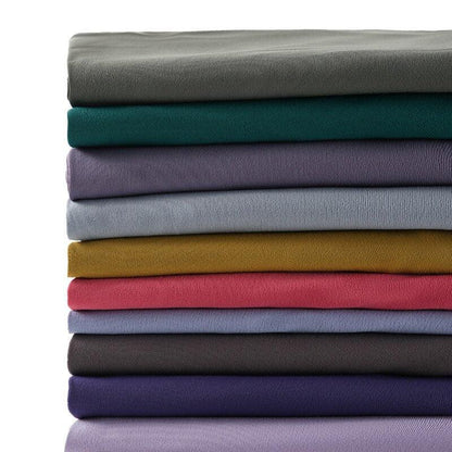 Stevvex leggings in assorted colors folded in a stack on Tampa Home & Garden Store