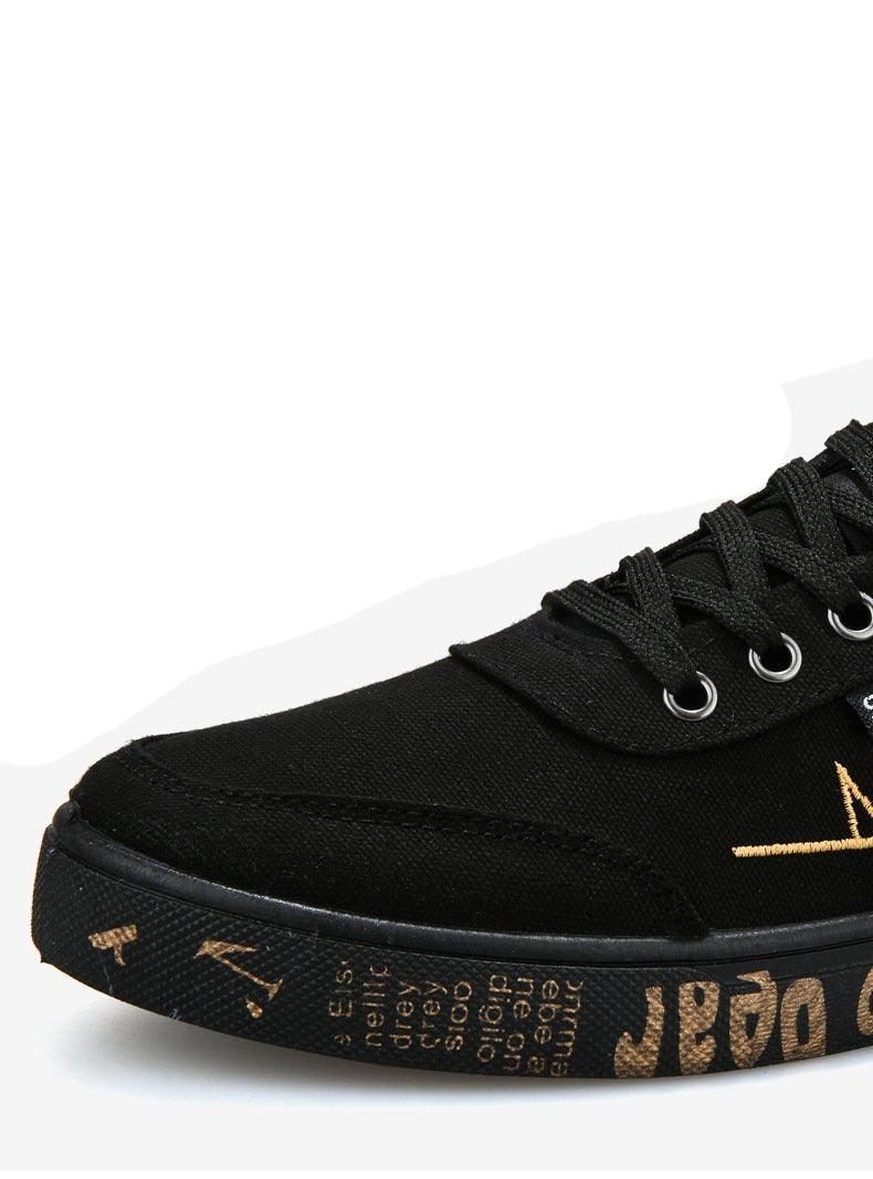 Stevvex black canvas sneakers, low-top lace-up casual walking flats with copper-toned sole lettering on Tampa Home & Garden Store
