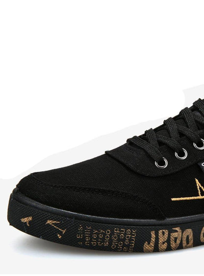 Stevvex black canvas sneakers, low-top lace-up casual walking flats with copper-toned sole lettering on Tampa Home & Garden Store