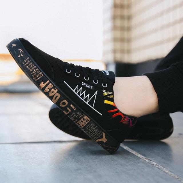Stevvex men's black canvas sneakers, low-top lace-up casual walking flats with colorful side graphic on Tampa Home & Garden Store