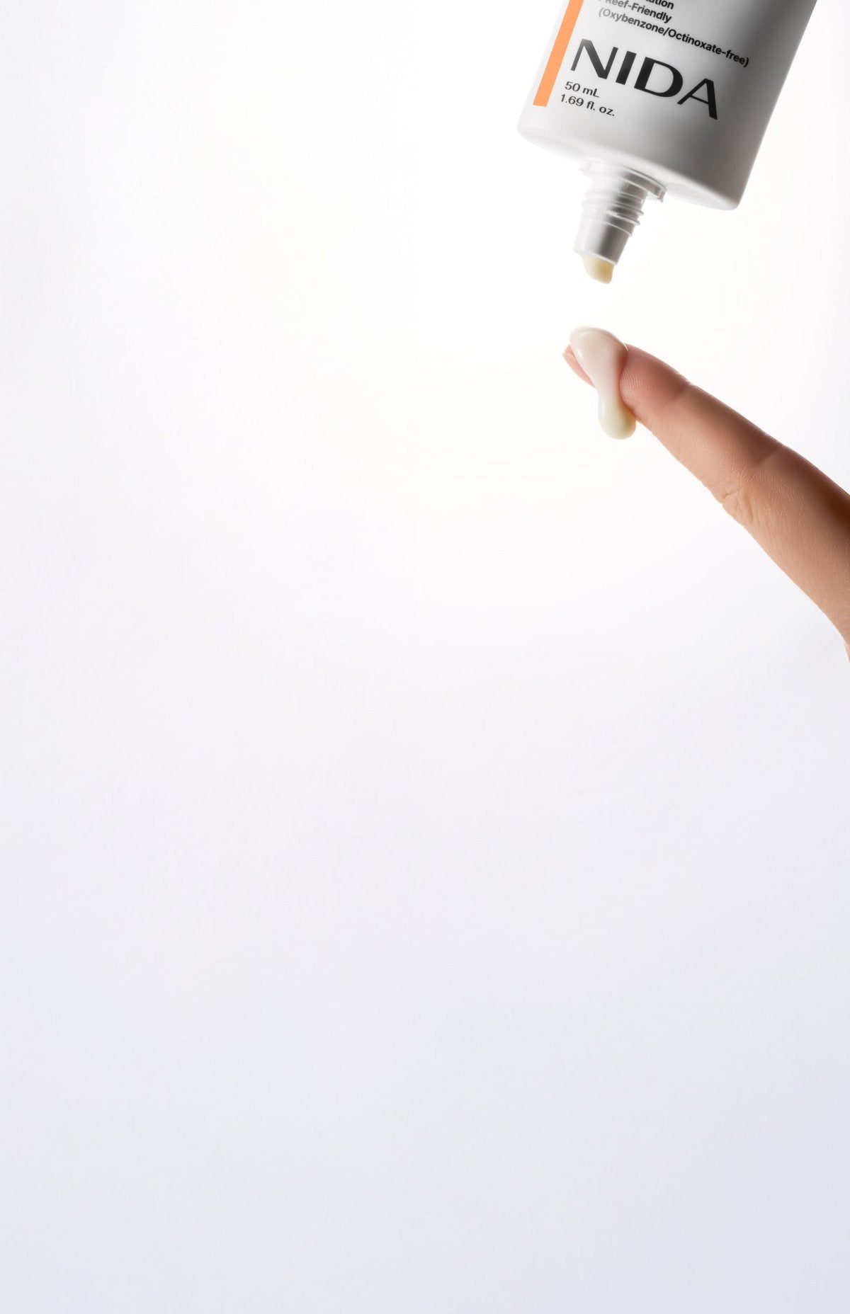 Sun cream NIDA Invisible Fit 50ml by Seoulia; sunscreen lotion dispensed onto fingertip on Tampa Home & Garden Store