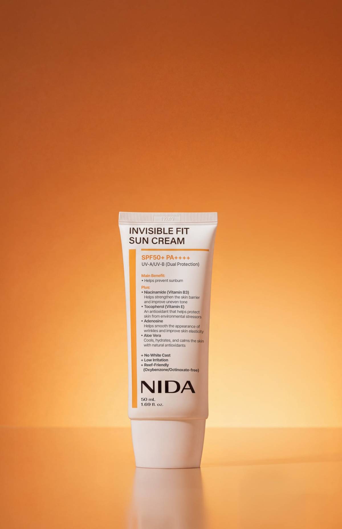 NIDA Invisible Fit Sun Cream white tube SPF50+ PA++++ sunscreen 50 ml on orange backdrop on Tampa Home & Garden Store