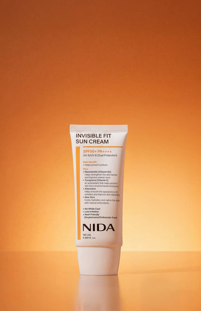 NIDA Invisible Fit Sun Cream white tube SPF50+ PA++++ sunscreen 50 ml on orange backdrop on Tampa Home & Garden Store