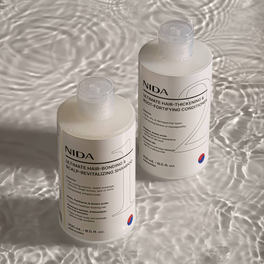 NIDA shampoo bottles, 250 ml, white plastic with clear pumps, two bottles on water backdrop on Tampa Home & Garden Store