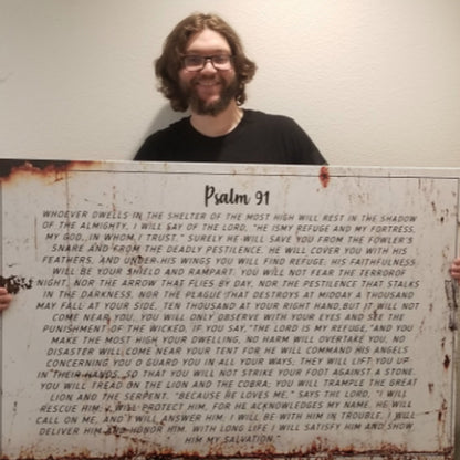 Psalm 91 canvas wall art by Tailored Canvases with rust-stain edges, held by a smiling man on Tampa Home & Garden Store