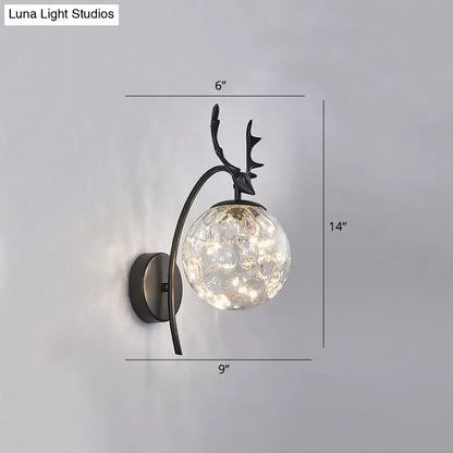Black Antler Wall Sconce by Decorbites with clear glass orb, curved arm, black metal finish on Tampa Home & Garden Store