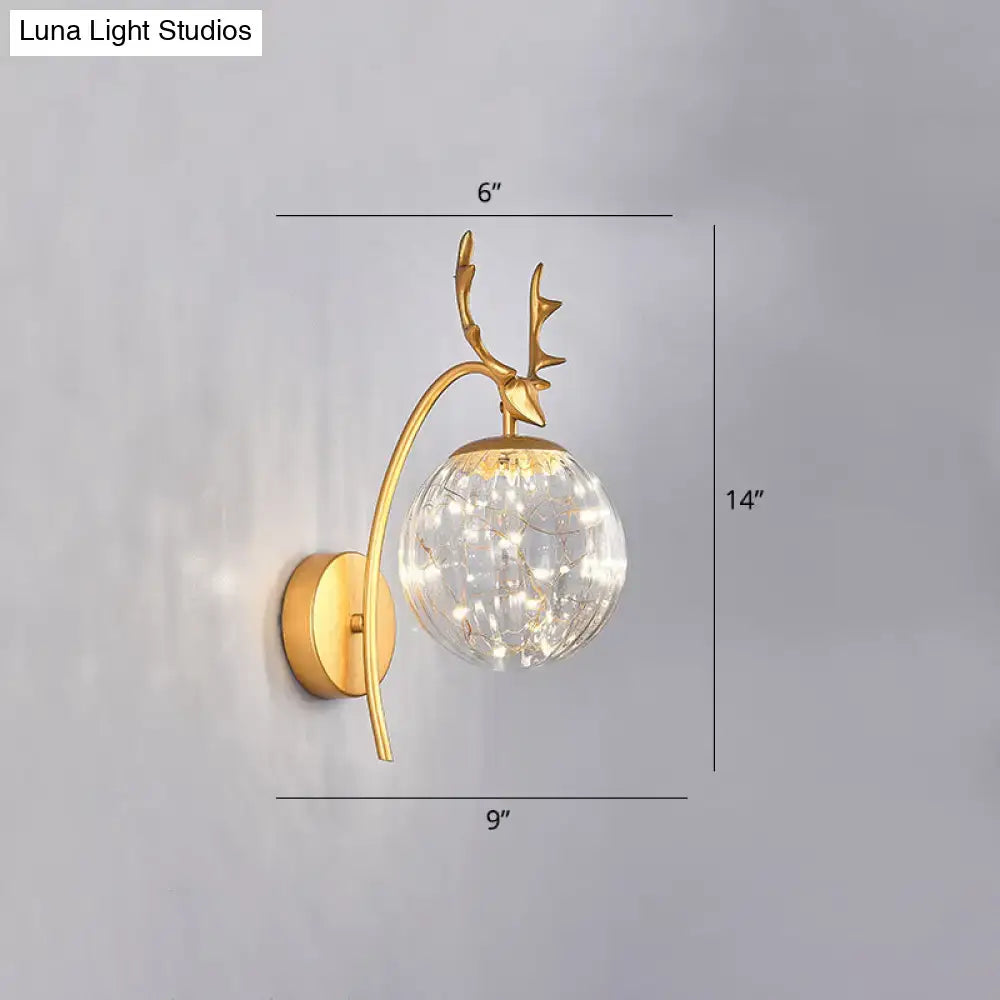 Black Antler Wall Sconce by Decorbites with gold finish, glass orb, and fairy lights on Tampa Home & Garden Store