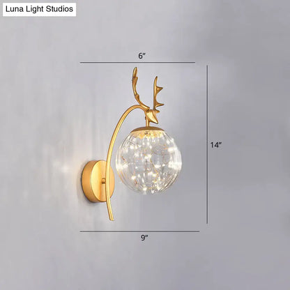 Black Antler Wall Sconce by Decorbites with gold finish, glass orb, and fairy lights on Tampa Home & Garden Store