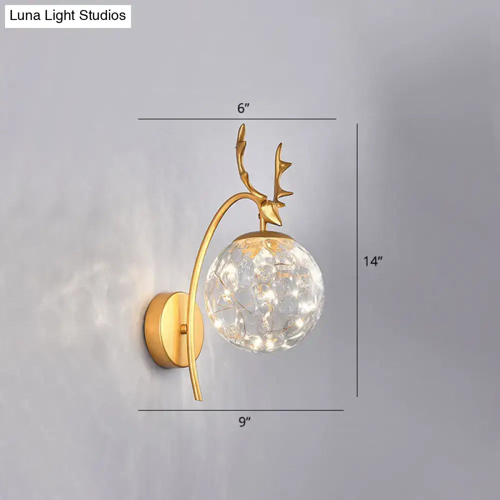Decorbites Black Antler Wall Sconce with brass curved arm and crystal glass globe on Tampa Home & Garden Store