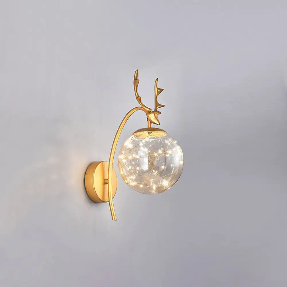 Decorbites gold antler wall sconce with glass globe and warm fairy lights on Tampa Home & Garden Store