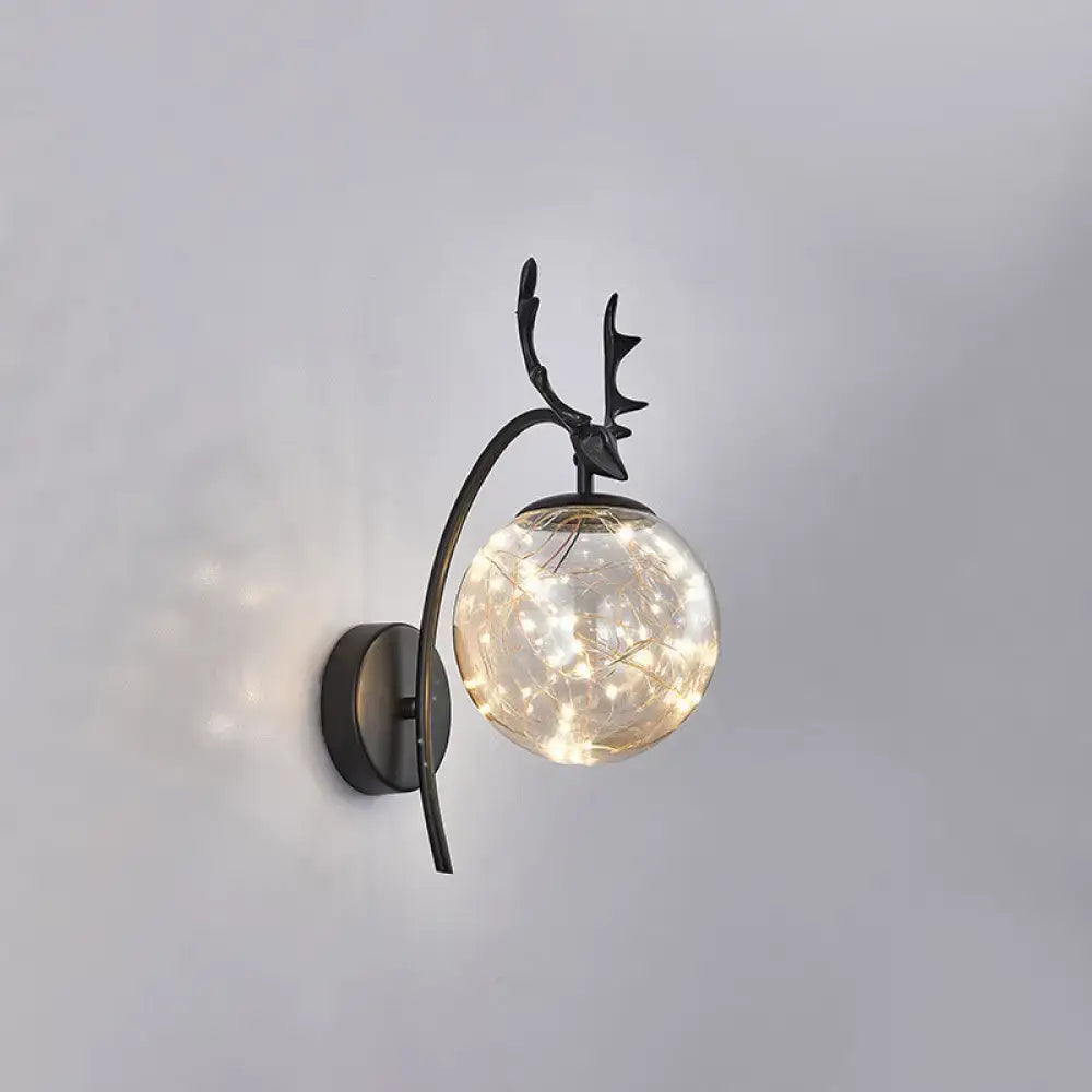 Black Antler Wall Sconce with curved metal arm and glass globe with string lights Decorbites on Tampa Home & Garden Store