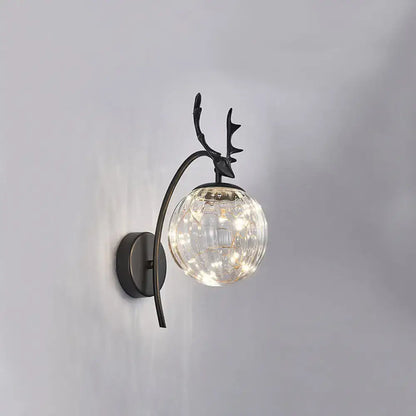 Decorbites Black Antler Wall Sconce with clear glass globe and warm LED lights on Tampa Home & Garden Store
