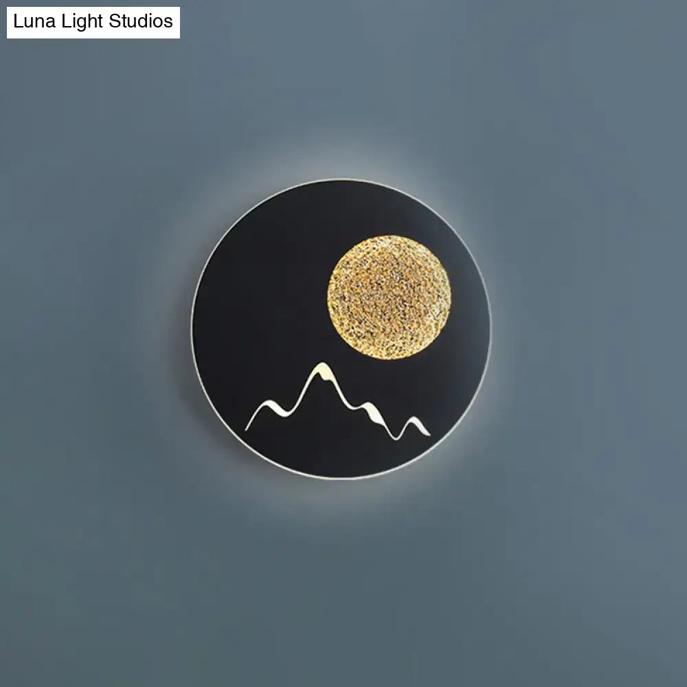 Metallic Mountain Wall Light by Decorbites; black round lamp with gold sun and white peaks on Tampa Home & Garden Store
