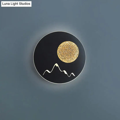 Metallic Mountain Wall Light by Decorbites; black round lamp with gold sun and white peaks on Tampa Home & Garden Store