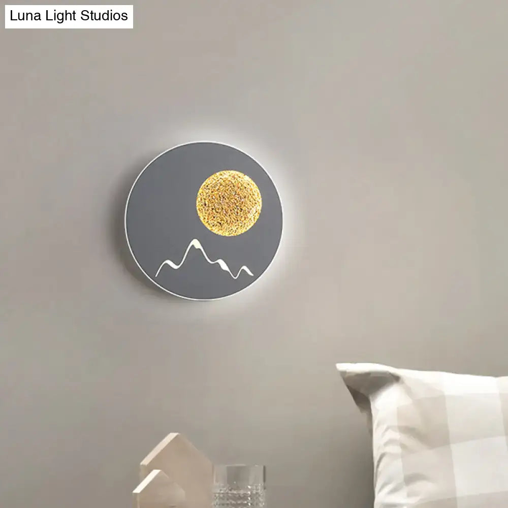 Metallic Mountain Wall Light; round gray metal sconce with white mountain line and gold sun glow on Tampa Home & Garden Store