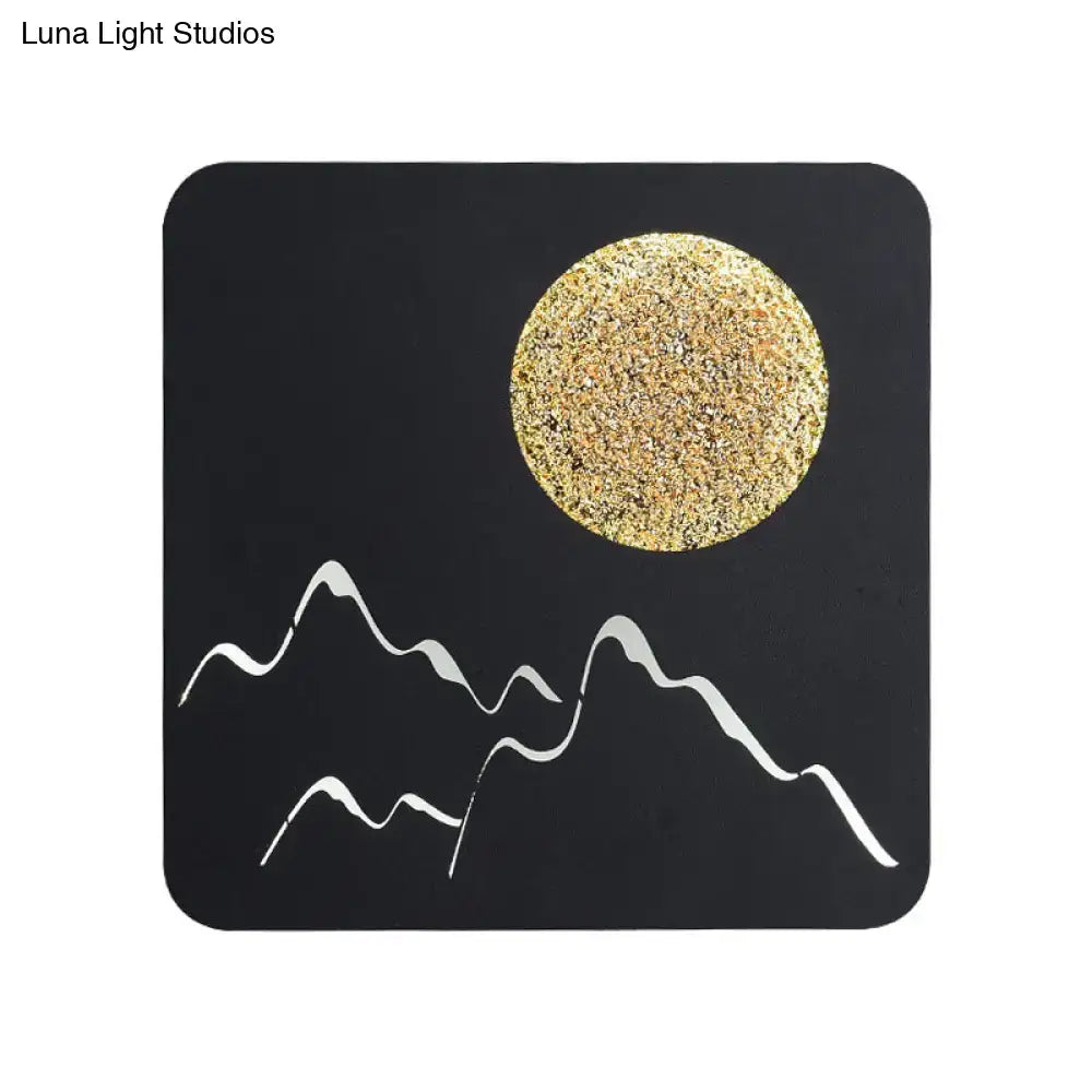 Metallic Mountain Wall Light by Decorbites on black panel with glitter sun and white mountains on Tampa Home & Garden Store