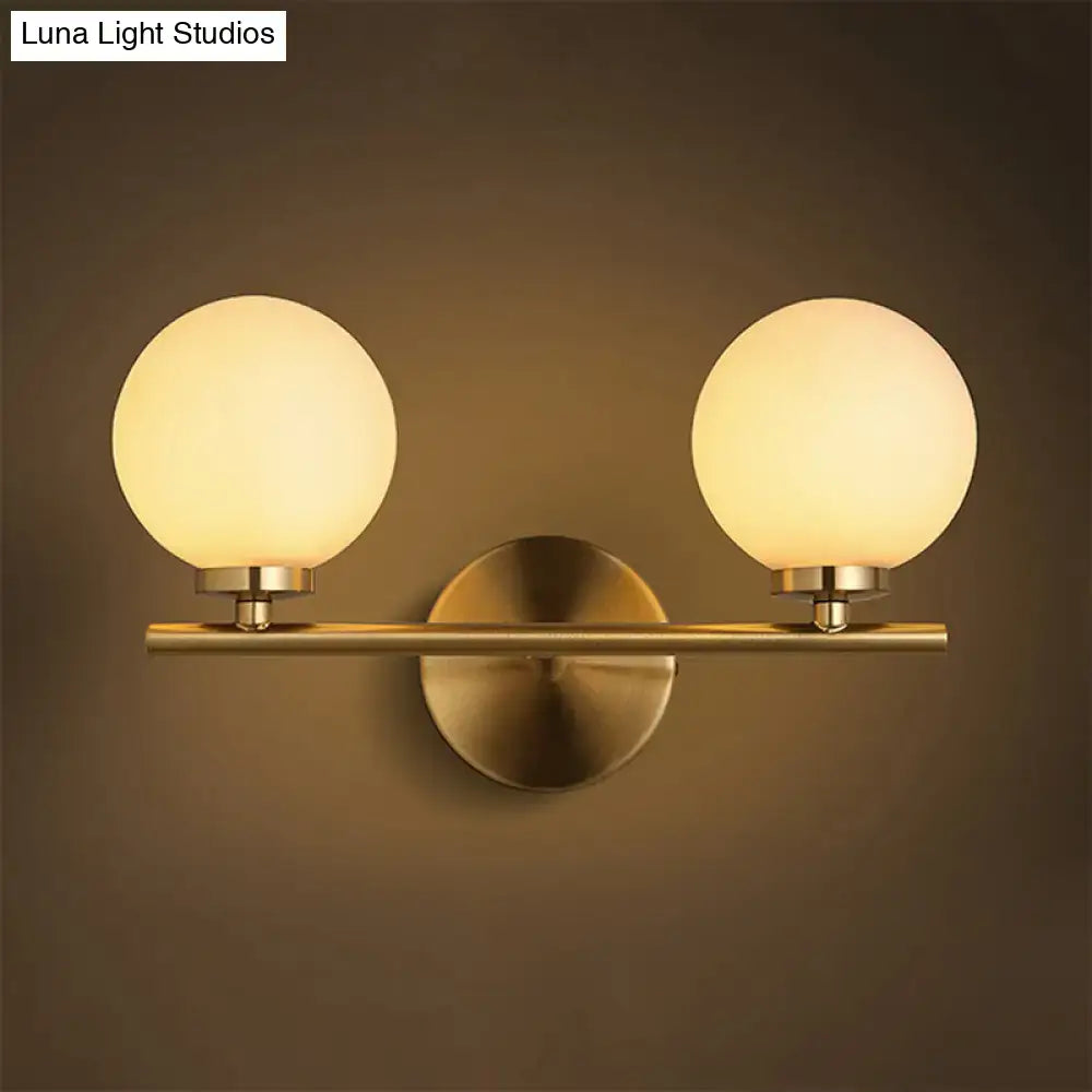 Brass Globe Compact Wall Sconce with two frosted glass globes on a brass bar Decorbites on Tampa Home & Garden Store