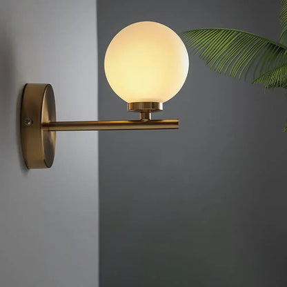 Brass Globe Compact Wall Sconce by Decorbites with frosted glass globe and brass arm on Tampa Home & Garden Store
