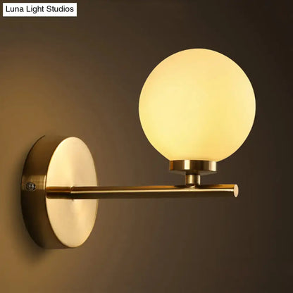 Brass Globe Compact Wall Sconce by Decorbites with frosted glass globe and brass arm on Tampa Home & Garden Store