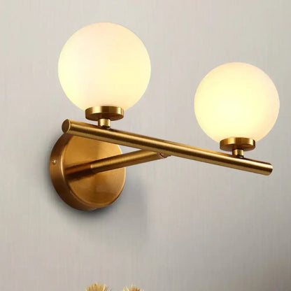 Brass Globe Compact Wall Sconce with two frosted globes Decorbites on Tampa Home & Garden Store