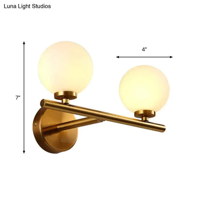 Brass Globe Compact Wall Sconce Decorbites with twin frosted glass globes on a bar on Tampa Home & Garden Store
