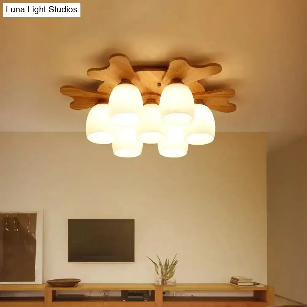 Cream glass bell ceiling light with wood leaf accents; Decorbites flush mount fixture on Tampa Home & Garden Store