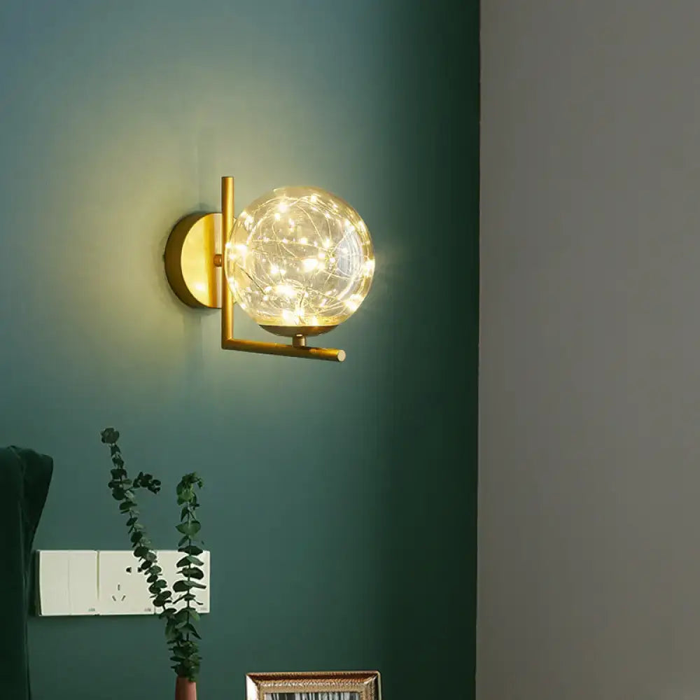 Gold glass globe wall sconce with brass finish by Decorbites on Tampa Home & Garden Store