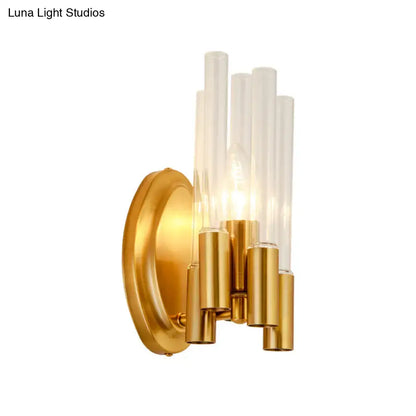 Gold tube wall lamp with clear glass tubes and brass cylindrical accents on Tampa Home & Garden Store