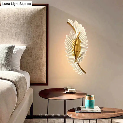 Wall light Decorbites gold feather wall sconce with white translucent blades in bedroom on Tampa Home & Garden Store