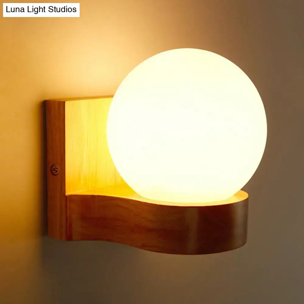 Opal glass wood sconce with warm orb on curved walnut base by Decorbites on Tampa Home & Garden Store