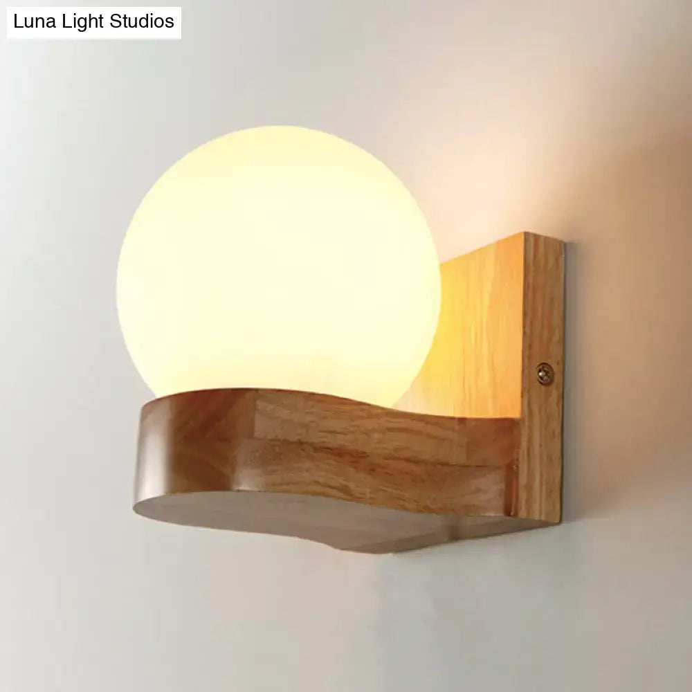 Opal Glass Wood Sconce by Decorbites with a warm round globe on a curved wood mount on Tampa Home & Garden Store